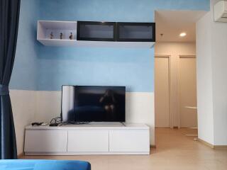 Modern living room with TV unit and floating shelf