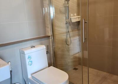 Modern bathroom with glass-enclosed shower and toilet