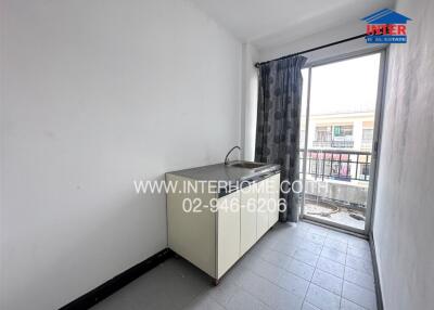 Small minimalist kitchen with sink, counter, and large window with balcony view