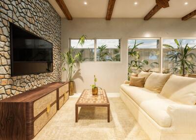 Modern living room with stone accent wall and large windows
