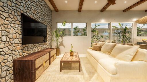 Modern living room with stone accent wall and large windows