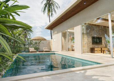 Modern outdoor pool area with sun loungers and tropical foliage