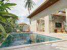 Modern outdoor pool area with sun loungers and tropical foliage