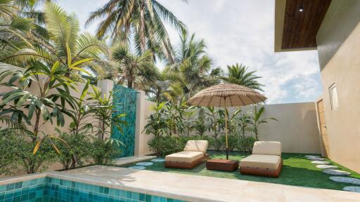 Outdoor area with pool, lounge chairs, parasol, and tropical plants