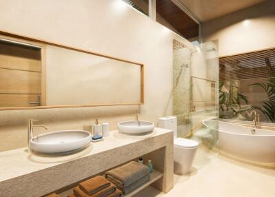 Modern and spacious bathroom with bathtub, double sinks, and shower