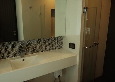 Modern bathroom with sink and glass shower door