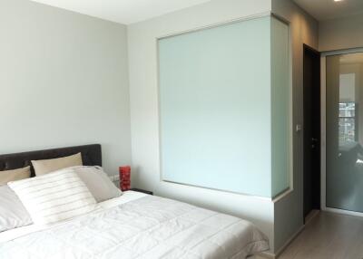 Modern bedroom with bed and decorative glass partition