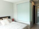 Modern bedroom with bed and decorative glass partition