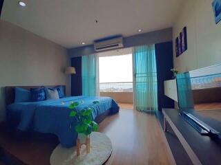 Modern bedroom with blue decor and large window