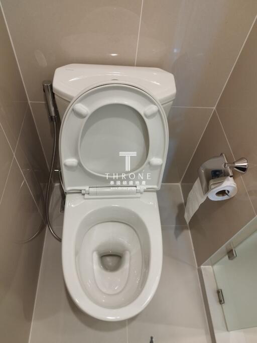 clean bathroom with toilet and paper holder