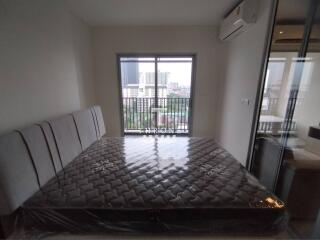 Modern bedroom with large window and city view