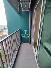 Outdoor balcony area with railing and view of surrounding buildings