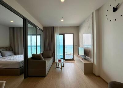 Living room with adjacent bedroom and ocean view