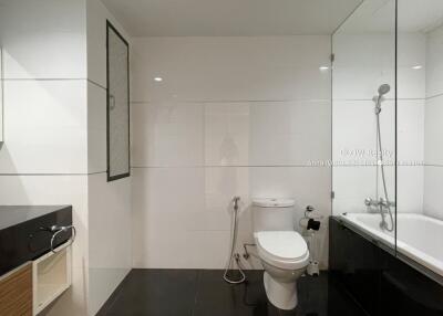 Modern bathroom with bathtub and black countertop