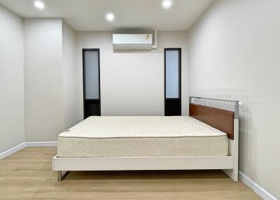 Simple bedroom with bed and air conditioning