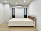 Simple bedroom with bed and air conditioning