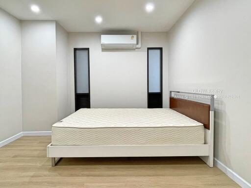 Simple bedroom with bed and air conditioning