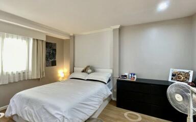 Cozy bedroom with white bedding and modern decor