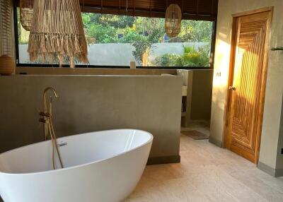 Modern bathroom with freestanding bathtub and natural light