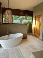 Modern bathroom with freestanding bathtub and natural light