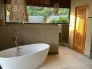 Modern bathroom with freestanding bathtub and natural light