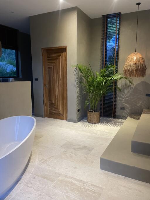 Modern bathroom with freestanding tub and natural decor