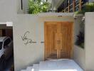 Stylish wooden door entryway of Villa Palma with covered parking space