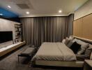 Modern bedroom with large bed, wall-mounted TV, and sleek furnishings
