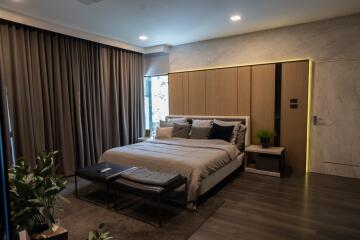 modern bedroom with large bed and accent lighting