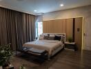 modern bedroom with large bed and accent lighting