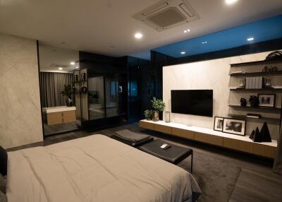Modern bedroom with wall-mounted TV and shelves