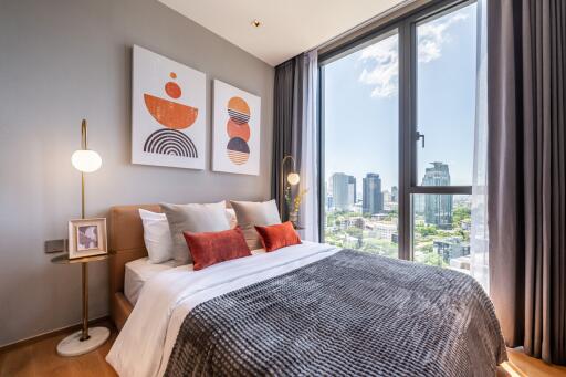 Modern bedroom with large window and city view