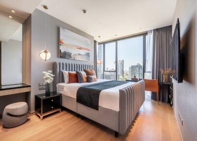 Modern bedroom with a large bed and city view