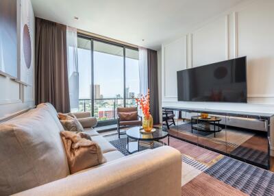 Modern living room with large TV and city view