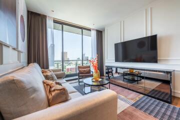 Modern living room with large TV and city view