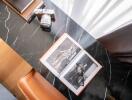 A study desk with a book, glasses, a camera, and a notebook