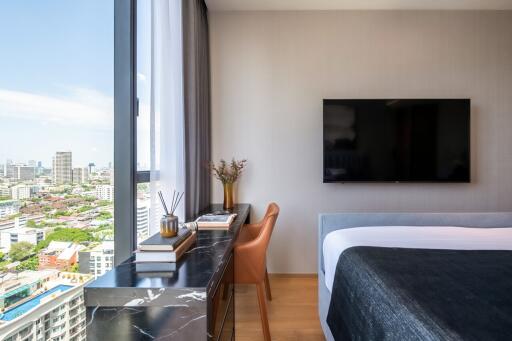 Modern bedroom with large window and city view