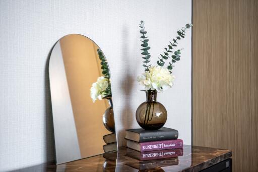 Styled bedroom vanity with mirror and decorative elements