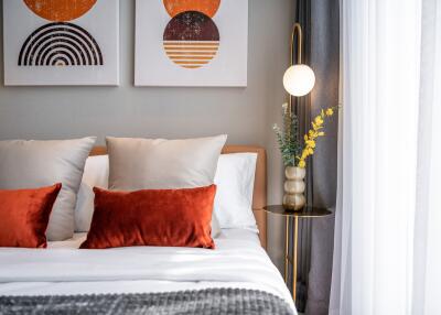 Modern bedroom with decorative pillows and wall art