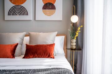 Modern bedroom with decorative pillows and wall art