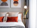 Modern bedroom with decorative pillows and wall art