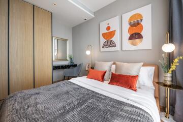 Modern bedroom with decorative art pieces and wooden wardrobe