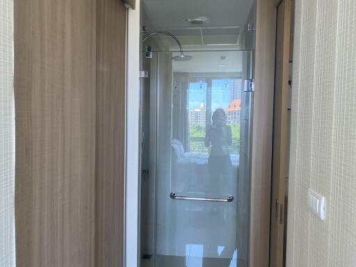 Modern bathroom with glass shower enclosure and wooden accents