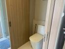 Compact bathroom with wooden sliding door