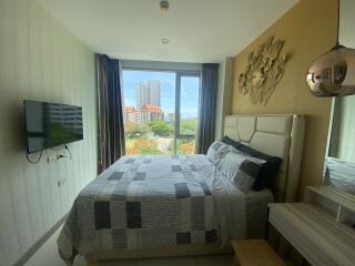 Modern bedroom with large window and city view