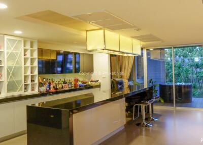Modern kitchen with island, bar stools, and glass sliding doors