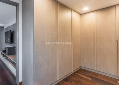 Spacious hallway with built-in wardrobes and wooden flooring