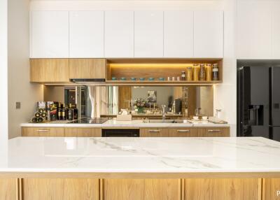 Modern kitchen with wooden cabinets and marble countertop
