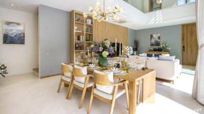 Modern open-plan living and dining area with wooden furniture and elegant decor