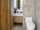 Modern bathroom with wooden door and marble tiles